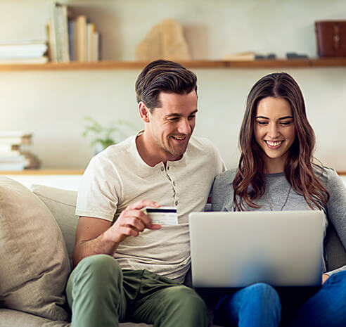 young couple paying a bill online together