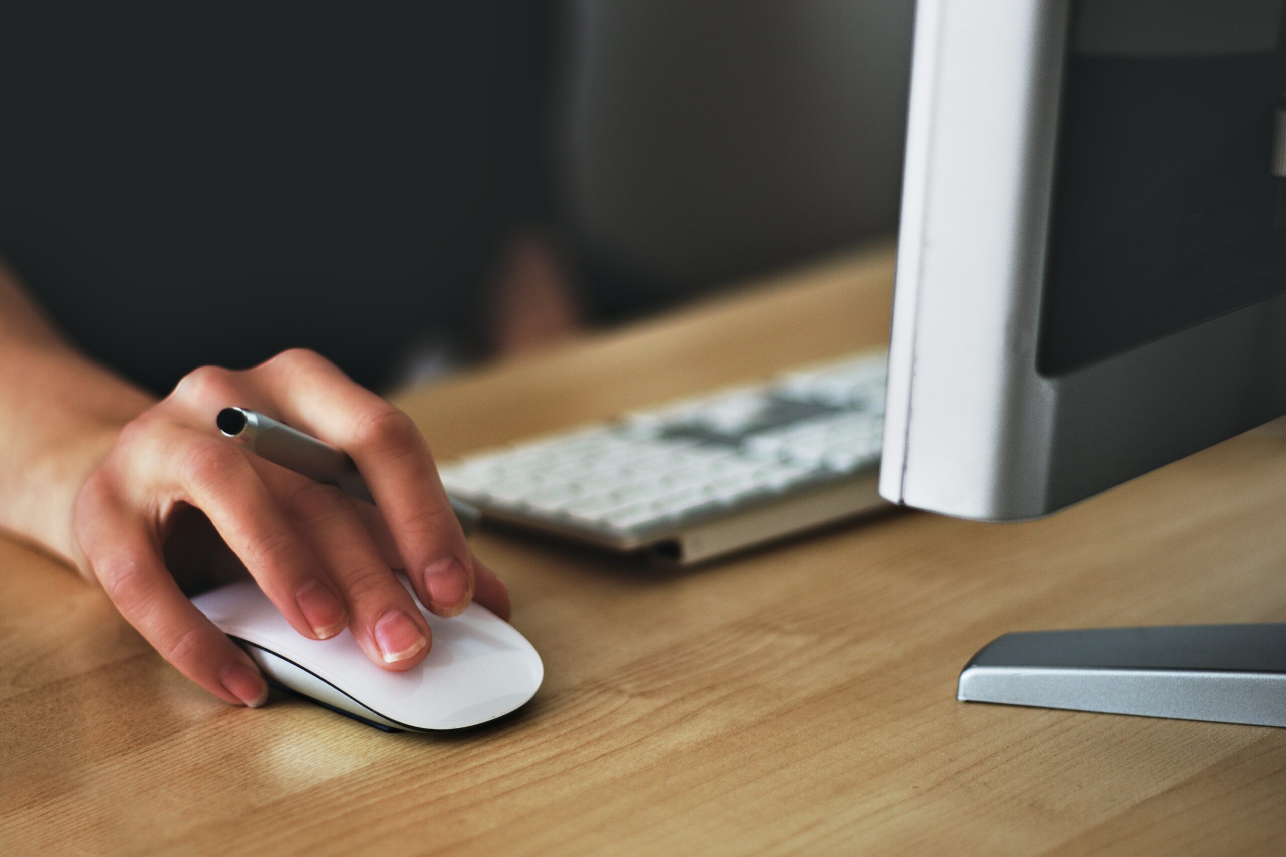 A zoomed-in photo of a hand on a computer mouse