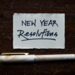 Small pen and paper with "New Year Resolutions" written on it