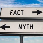 A road sign pointing right for "fact" and left for "myth"