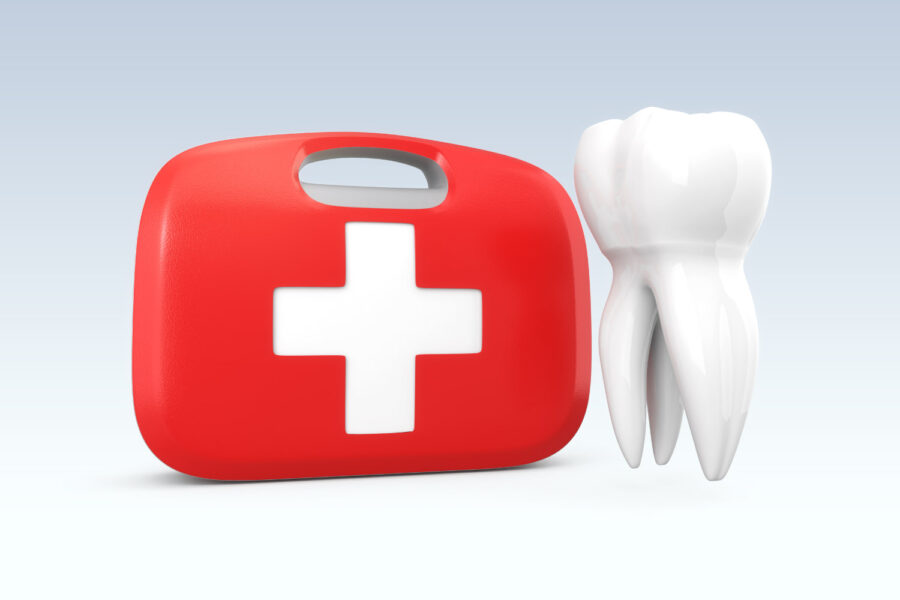 A white tooth floats next to a red and white first aid kit to indicate a dental emergency