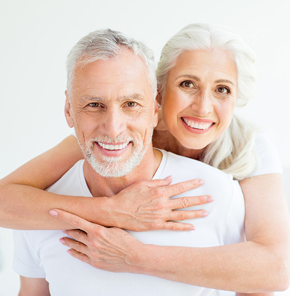Photograph of two smiling senior adults, a man and woman accompaying a dental article about dental tips for seniors.