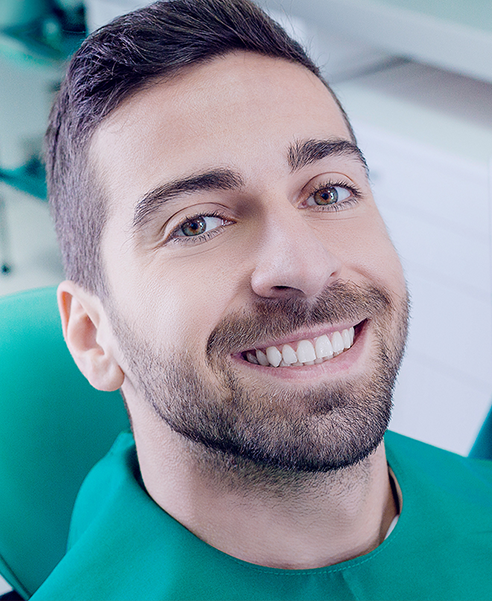 man smiling at dentist