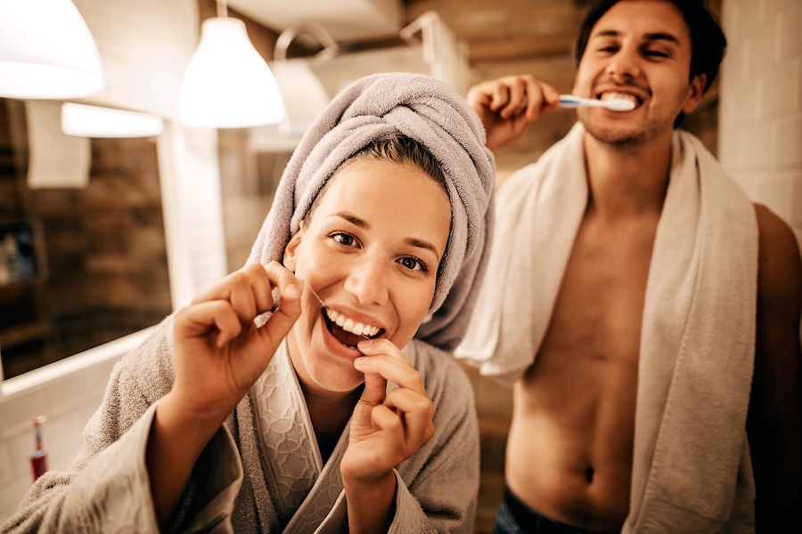 couple brushing and flossing for their 2025 oral health goals